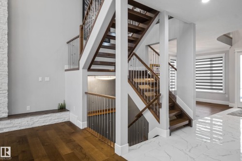 Stairs featuring baseboards and wood finished floors - 4086 Whispering River Drive, Edmonton, AB - Indoor Photo Showing Other Room