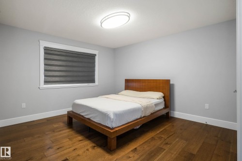 Bedroom with dark wood-style flooring - 4086 Whispering River Drive, Edmonton, AB - Indoor Photo Showing Bedroom