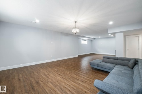 Living area featuring dark wood finished floors and recessed lighting - 4086 Whispering River Drive, Edmonton, AB - Indoor