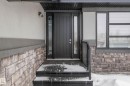 Property entrance with stone siding and stucco siding - 4086 Whispering River Drive, Edmonton, AB  - Outdoor With Exterior 