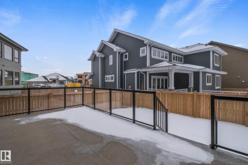Rear view of house featuring a fenced backyard, a residential view, and a patio - 4086 Whispering River Drive, Edmonton, AB - Outdoor
