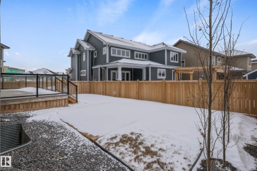 Snow covered house featuring a deck and a fenced backyard - 4086 Whispering River Drive, Edmonton, AB - Outdoor With Deck Patio Veranda