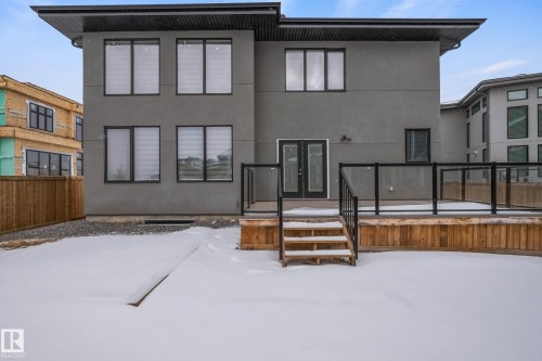 Snow covered rear of property featuring french doors and stucco siding - 4086 Whispering River Drive, Edmonton, AB - Outdoor With Exterior