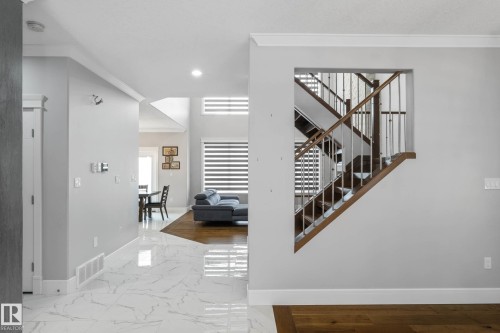Stairs featuring ornamental molding, marble finish floors, and recessed lighting - 4086 Whispering River Drive, Edmonton, AB - Indoor Photo Showing Other Room