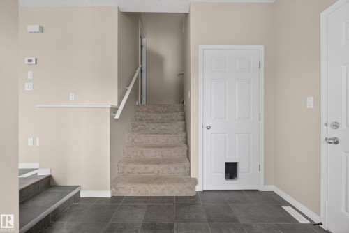Stairs featuring tile patterned flooring and baseboards - 2704 Coughlan Green, Edmonton, AB - Indoor Photo Showing Other Room