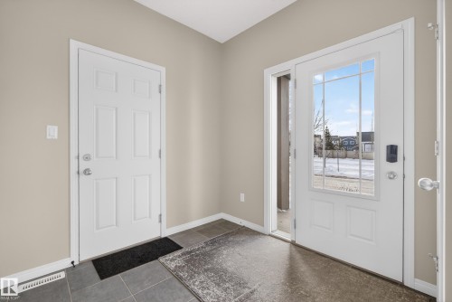Foyer with baseboards and dark tile patterned flooring - 2704 Coughlan Green, Edmonton, AB - Indoor Photo Showing Other Room