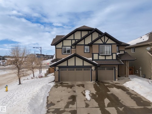 Tudor-style house with roof with shingles, driveway, and a garage - 2704 Coughlan Green, Edmonton, AB - Outdoor