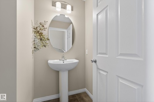 Half bathroom with baseboards and dark tile patterned floors - 2704 Coughlan Green, Edmonton, AB - Indoor Photo Showing Bathroom