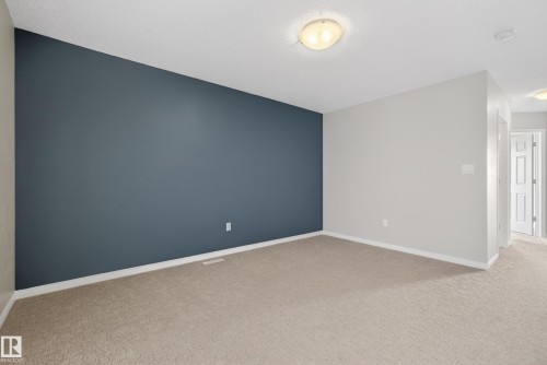 Unfurnished room with baseboards and light carpet - 2704 Coughlan Green, Edmonton, AB - Indoor Photo Showing Other Room