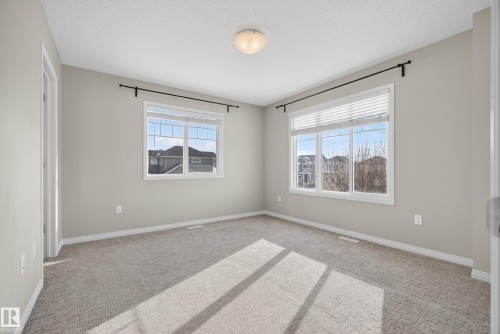 Unfurnished room with light carpet and a textured ceiling - 2704 Coughlan Green, Edmonton, AB - Indoor Photo Showing Other Room