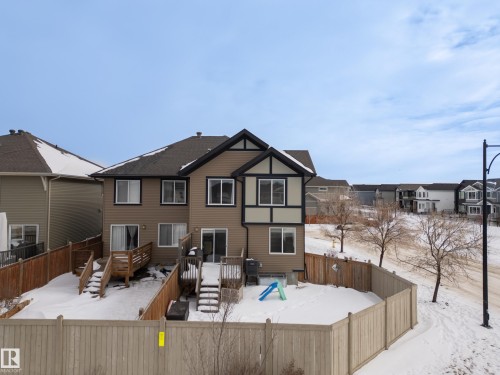 Snow covered property with a fenced backyard, a residential view, and a deck - 2704 Coughlan Green, Edmonton, AB - Outdoor