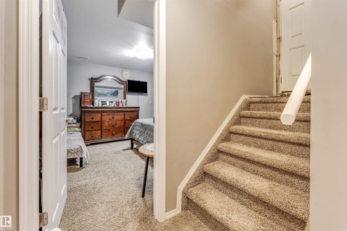 Stairs with carpet and baseboards - 4404 150 Avenue, Edmonton, AB - Indoor Photo Showing Other Room