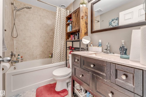 Bathroom featuring vanity and shower / bathtub combination with curtain - 4404 150 Avenue, Edmonton, AB - Indoor Photo Showing Bathroom
