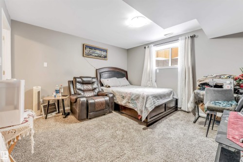 Bedroom with light carpet and baseboards - 4404 150 Avenue, Edmonton, AB - Indoor Photo Showing Bedroom
