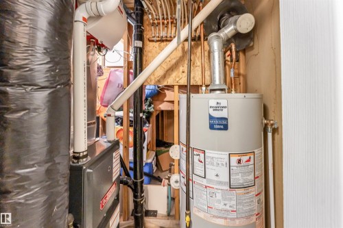 Utility room with gas water heater and heating unit - 4404 150 Avenue, Edmonton, AB - Indoor Photo Showing Basement
