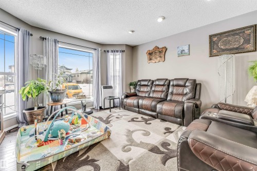 Living area featuring a textured ceiling - 4404 150 Avenue, Edmonton, AB - Indoor Photo Showing Living Room