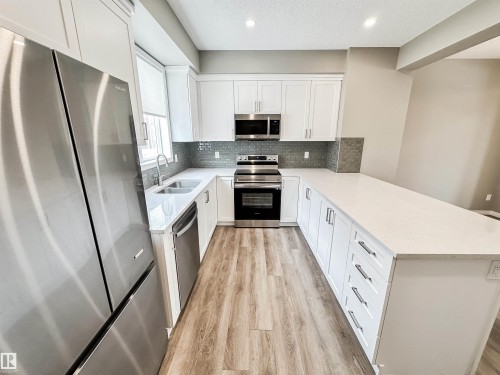100 2072 Wonnacott Way, Edmonton, AB - Indoor Photo Showing Kitchen With Stainless Steel Kitchen With Double Sink