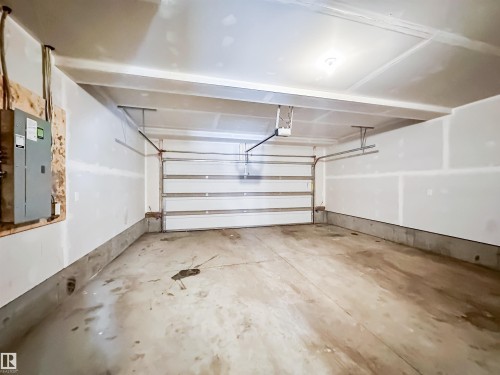 100 2072 Wonnacott Way, Edmonton, AB - Indoor Photo Showing Garage