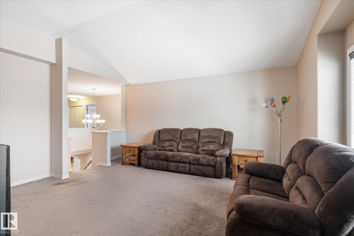 Living room featuring lofted ceiling, hanging lights, and light carpet - 66 Nadine Way, St. Albert, AB - Indoor Photo Showing Living Room