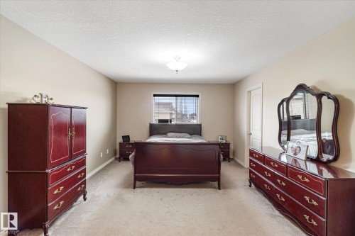 Bedroom featuring a textured ceiling and light carpet - 66 Nadine Way, St. Albert, AB - Indoor Photo Showing Bedroom