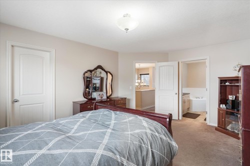 Bedroom featuring carpet floors and ensuite bath - 66 Nadine Way, St. Albert, AB - Indoor Photo Showing Bedroom