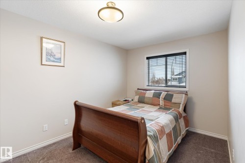 Bedroom featuring dark colored carpet and baseboards - 66 Nadine Way, St. Albert, AB - Indoor Photo Showing Bedroom