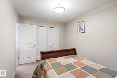 Bedroom featuring carpet flooring, a textured ceiling, and a closet - 66 Nadine Way, St. Albert, AB - Indoor Photo Showing Bedroom