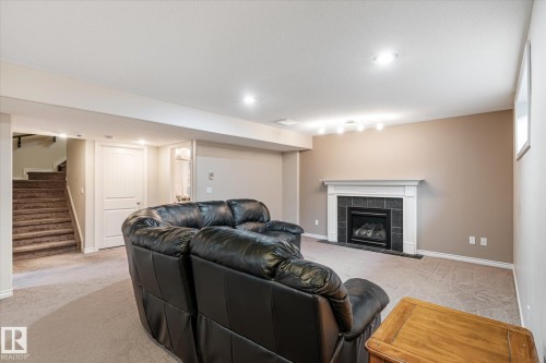 Living area with light carpet, recessed lighting, and a fireplace - 66 Nadine Way, St. Albert, AB - Indoor With Fireplace