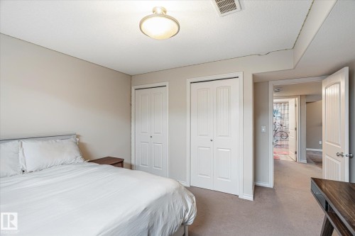 Bedroom featuring two closets and carpet flooring - 66 Nadine Way, St. Albert, AB - Indoor Photo Showing Bedroom