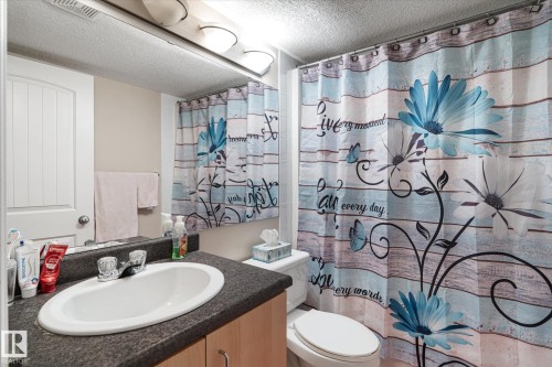 Full bath with vanity, curtained shower, and a textured ceiling - 66 Nadine Way, St. Albert, AB - Indoor Photo Showing Bathroom