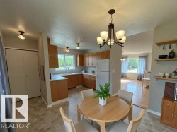 Dining space with a chandelier and baseboards - 