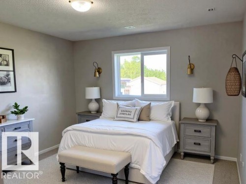 Bedroom featuring a textured ceiling and light carpet - 130 1 Street, Blue Ridge, AB - Indoor Photo Showing Bedroom