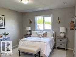 Bedroom featuring a textured ceiling and light carpet - 