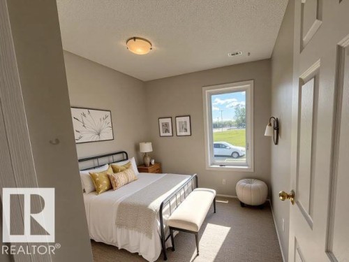 Bedroom featuring a textured ceiling and carpet flooring - 130 1 Street, Blue Ridge, AB - Indoor Photo Showing Bedroom