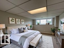 Bedroom with a drop ceiling and light colored carpet - 