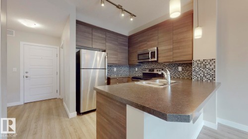 109 2590 Anderson Way Sw, Edmonton, AB - Indoor Photo Showing Kitchen With Stainless Steel Kitchen With Double Sink