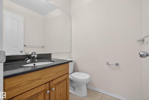 Half bathroom featuring vanity and light tile patterned floors - 11435 37A Avenue, Edmonton, AB - Indoor Photo Showing Bathroom