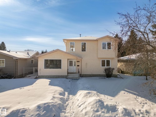 Snow covered rear of property featuring stucco siding - 11435 37A Avenue, Edmonton, AB - Outdoor