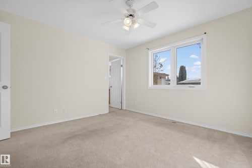 Unfurnished room with light colored carpet and a ceiling fan - 11435 37A Avenue, Edmonton, AB - Indoor Photo Showing Other Room