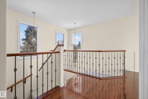 Hall featuring dark wood-type flooring, an upstairs landing, and a chandelier - 11435 37A Avenue, Edmonton, AB - Indoor Photo Showing Other Room