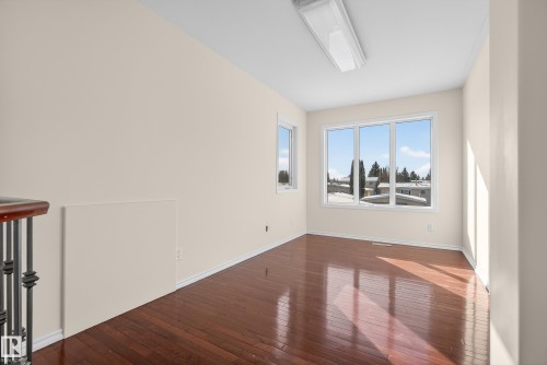 Spare room with dark wood-style floors and baseboards - 11435 37A Avenue, Edmonton, AB - Indoor Photo Showing Other Room