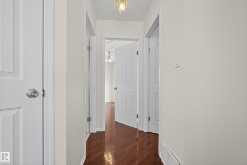 Hall featuring dark wood-style flooring and baseboards - 11435 37A Avenue, Edmonton, AB - Indoor Photo Showing Other Room