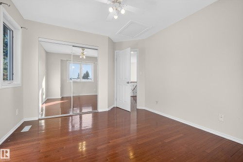 Unfurnished bedroom with dark wood-style floors, ceiling fan, and a closet - 11435 37A Avenue, Edmonton, AB - Indoor Photo Showing Other Room