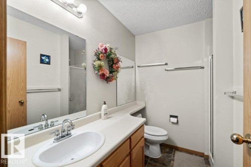Bathroom featuring a textured ceiling, vanity, and a stall shower - 10429 28A Avenue, Edmonton, AB - Indoor Photo Showing Bathroom