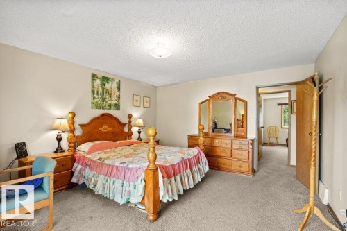 Bedroom featuring light colored carpet and a textured ceiling - 10429 28A Avenue, Edmonton, AB - Indoor Photo Showing Bedroom