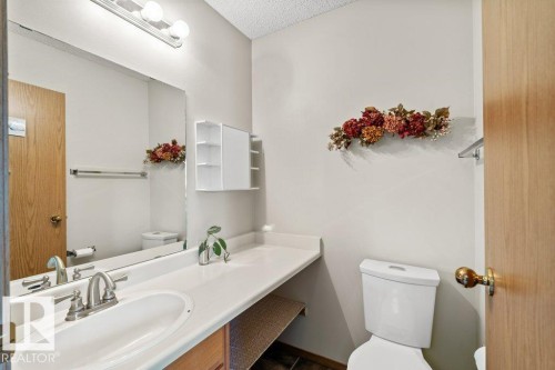 Bathroom with vanity and a textured ceiling - 10429 28A Avenue, Edmonton, AB - Indoor Photo Showing Bathroom