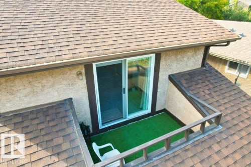 View of property exterior featuring a shingled roof and stucco siding - 10429 28A Avenue, Edmonton, AB - Outdoor With Exterior