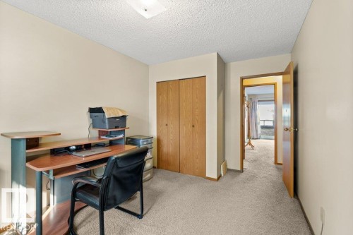 Office area featuring carpet flooring and a textured ceiling - 10429 28A Avenue, Edmonton, AB - Indoor