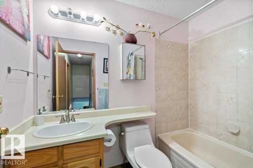 Bathroom with  shower combination, vanity, and a textured ceiling - 10429 28A Avenue, Edmonton, AB - Indoor Photo Showing Bathroom