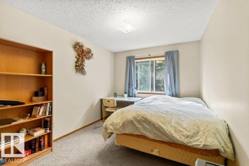 Bedroom featuring light carpet and a textured ceiling - 10429 28A Avenue, Edmonton, AB - Indoor Photo Showing Bedroom